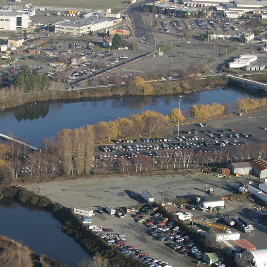 Aerial Photo of the Norfolk CSO area. Image shows multiple parking lots near the waterway area and the shoreline lines with a few trees.