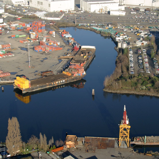 Aerial photo Slip 4 cleanup location, looking northeast. Two barges are docked for loading or offloading of shipping containers.