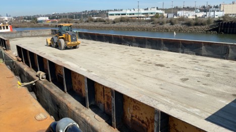 2026_0302 Empty Barge PC Geosyntec A piece of construction equipment on an empty barge.